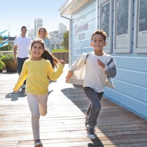 Kids running on the pier