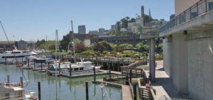 PIER 39 Marina with boats in water and city skyline in background