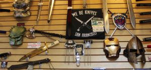 Helmets, swords and knives on a wall display